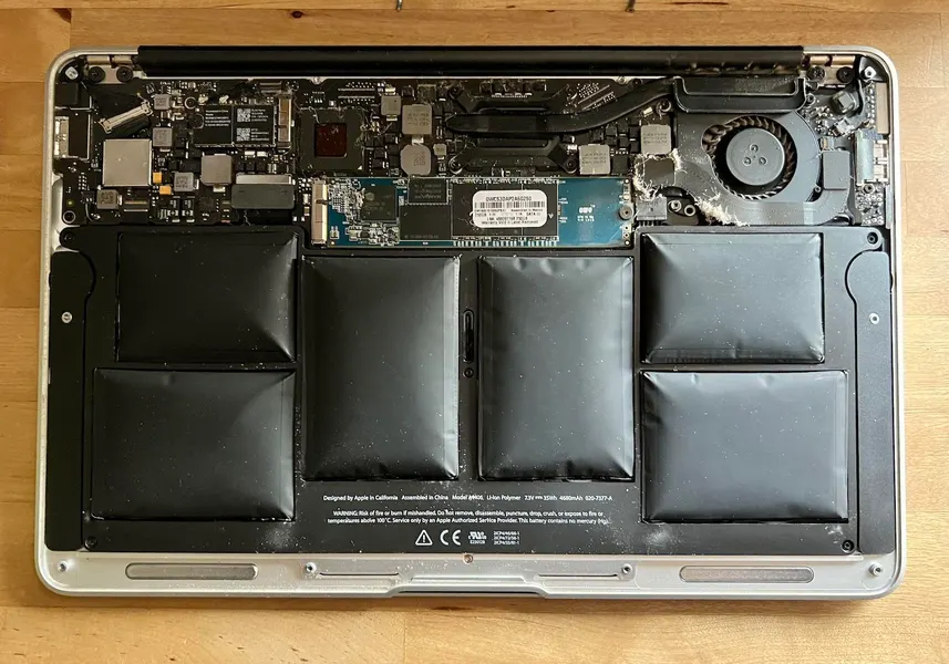 Swollen laptop battery causing lifted trackpad and warped bottom case in Pune – safety warning